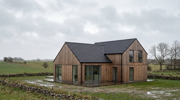 Detached Scandinavian house with dark profiled steel roof tiles